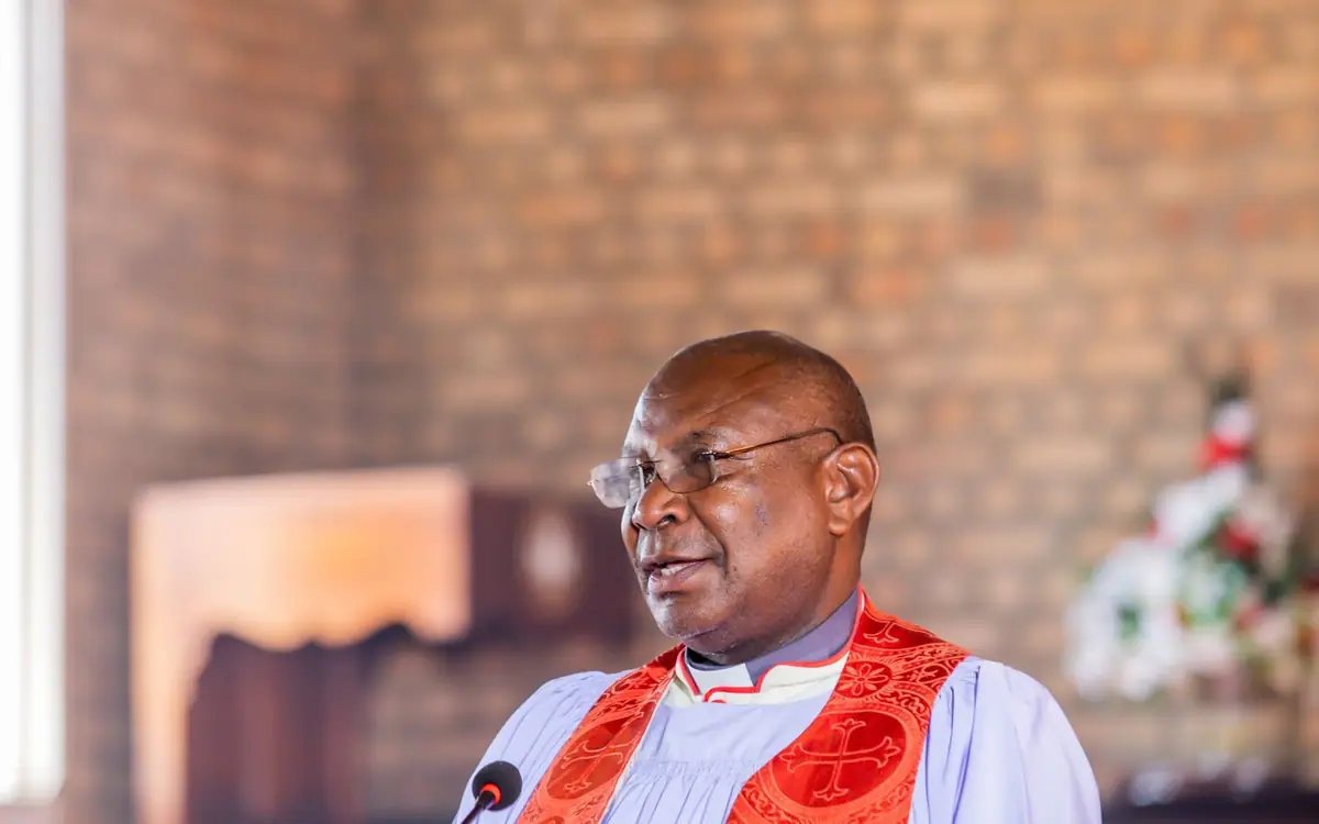 African clergyman preaching to a congregation during a church service